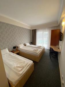 Postel nebo postele na pokoji v ubytování Hotel Stadion