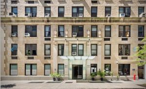 a large brick building with a door in front at 73-201 New 1BR 1Bth UWS Doorman Gym in New York