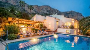 a villa with a swimming pool and a house at Casa Chilango in Montgo +42 photos