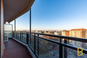 a balcony with a view of a city at BePlace Apartments in Primaticcio in Milan