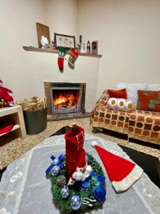 a living room with a santa hat and a fireplace at Saint Nicholas heights in Chakistra
