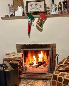 a fireplace with a christmas stocking hanging on the wall at Saint Nicholas heights in Chakistra