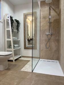 a bathroom with a glass shower with a toilet at Panoramic Apartment in Cumbre del Sol