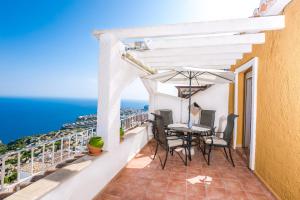 a balcony with a table and chairs and the ocean at Panoramic Apartment in Cumbre del Sol