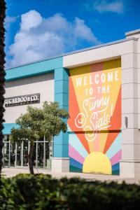 a building with a welcome to the gym and sale sign on it at Four Points by Sheraton Fort Lauderdale Airport - Dania Beach in Dania Beach