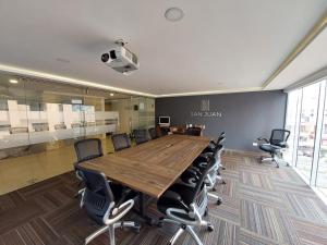 a conference room with a large wooden table and chairs at San Juan Hotel Boutique Pasto in Pasto +29 photos