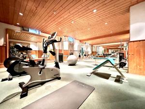 a gym with a treadmill and a exercise bike at GANSL Hotel & Residences in Saalfelden am Steinernen Meer