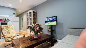 a living room with a table and a tv at AC Apartaments Centre in Pas de la Casa