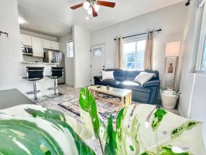 a living room with a blue couch and a table at Charming Flat Near The City in San Diego +8 photos