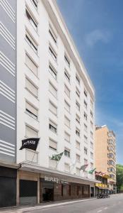 a large white building with a sign on it at DELPLAZA Timbiras São Paulo in São Paulo