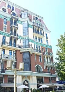 a tall building with umbrellas in front of it at Monte Carlo in Batumi