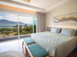 伊利亚贝拉Hotel Velas do Engenho的一间卧室，配有一张大床和一扇大窗户。