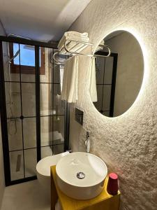 a bathroom with a sink and a mirror at Old Town Deluxe Flats in Antalya