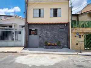 een huis met een deur en bloemen ervoor bij Studio Ideal in Sao Paulo