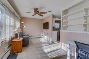 a living room with a ceiling fan and a couch at Aurora Horse Farm Apartment Near Denver! in Aurora