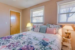 a bedroom with a bed and two windows at Aurora Horse Farm Apartment Near Denver! in Aurora