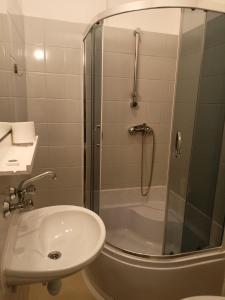 a bathroom with a shower and a sink and a toilet at AGRO obiekt hotelowy in Wrocław