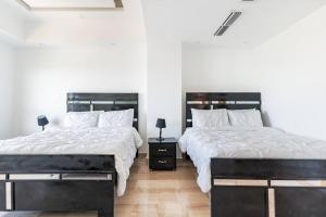 Postelja oz. postelje v sobi nastanitve Luxurious 2BDR with Ocean View