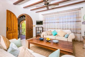 a living room with a couch and a table at Casa Toscana in Jávea