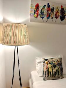 a lamp sitting next to a couch with a pillow at Fashion Chiado - SSs Apartments in Lisbon