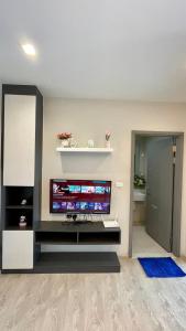 a living room with a large flat screen tv at The base Central 1006 by Numam in Pattaya