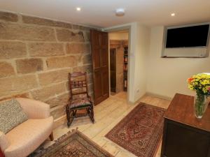 a living room with a couch and a chair at The Farmhouse in Keighley