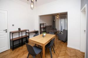 a living room with a wooden table and chairs at Perfect Long-term Stay Stylish and Spacious Top Center Next to Vitosha Blvd in Sofia