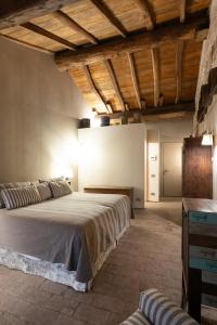 a bedroom with two beds in a room with wooden ceilings at Antica Corte Pallavicina Relais in Polesine Parmense