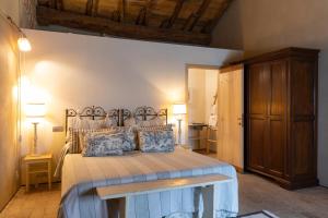 a bedroom with a large bed with a wooden ceiling at Antica Corte Pallavicina Relais in Polesine Parmense