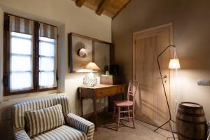 a living room with a desk and a chair and a lamp at Antica Corte Pallavicina Relais in Polesine Parmense