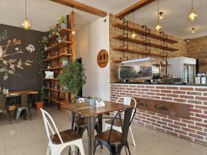 a restaurant with a table and chairs and a brick wall at Zemilo Hotel Apartment in Addis Ababa