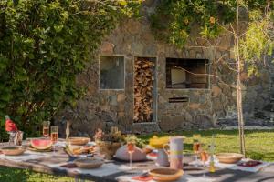 einen Tisch mit Nahrung vor einem Steingebäude in der Unterkunft Botanica Living Magnolia Apt in Quinta Grande