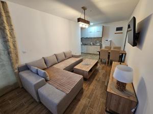 a living room with a couch and a table at Apartman Stoiljković in Kopaonik