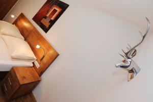 a bedroom with a bed with a metal lamp on the wall at Kleiner Turm 1 in Schruns-Tschagguns