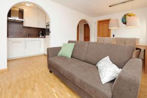 a living room with a couch and a kitchen at Kleiner Turm 02 in Schruns