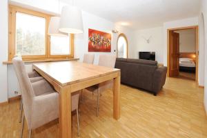 a living room with a dining room table and a couch at Kleiner Turm 02 in Schruns