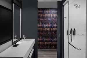 a bathroom with a shower and a sink at Aloft New York Chelsea in New York