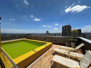 a swimming pool on the roof of a building at TrevizZo Vergueiro in São Paulo