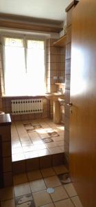 a bathroom with a window and a tiled floor at La Corte sul Conero Casa Vacanze in Camerano