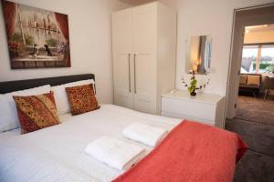 a bedroom with a white bed with two pillows at Walnut Flats-F5, Stylish 1-Bedroom - Parking, Netflix, WIFI - Close to Oxford, Bicester & Blenheim Palace in Kidlington