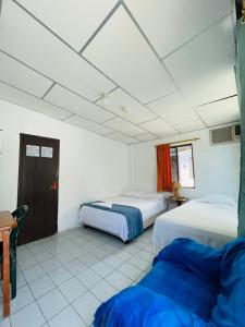 מיטה או מיטות בחדר ב-Hostal Darwin B&B