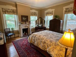 a bedroom with a bed and a fireplace at The Hollinger House in Lancaster