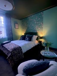 a bedroom with a bed and a wall with flowers at Number Two Russell House Tavistock Devon in Tavistock
