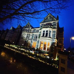 a large building with christmas lights in front of it at CoffiCo Hotel in Cardiff