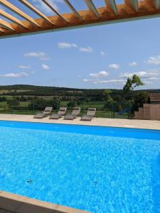 - une piscine avec vue sur la campagne dans l'établissement Large Gte With Pool In Peaceful Burgundy, à Sailly