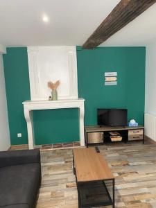 a living room with a couch and a tv at Philibert's Appartment - For Two Tournus in Tournus