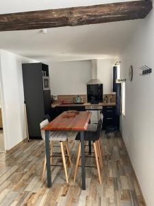 a kitchen with a wooden table in a room at Philibert's Appartment - For Two Tournus in Tournus