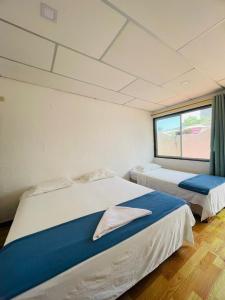 Postel nebo postele na pokoji v ubytování Hostal Darwin