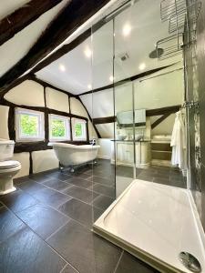 a bathroom with a tub and a toilet and a sink at The Manor at Abberley in Abberley