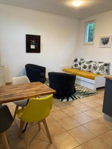 a living room with a table and chairs and a couch at La Rosaire in Soulac-sur-Mer